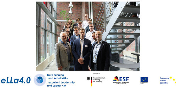 Group photo of the project "eLLa4.0 - Sociodigital Transformation towards Excellent Leadership and Labour" at a staircase of the Social Research Centre.