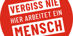 Grafik: Roter Kreis mit weißer Schrift "VERGISS NIW HIER ARBEITET EIN MENSCH"