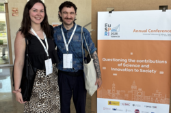 Photo: Katharina Hast and Julius Wiegand stand next to a poster for Eu-SPRI