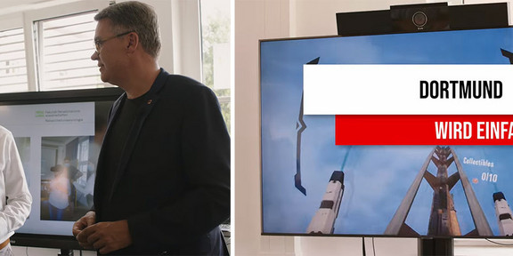 Vertr.-Prof. Dr. Bastian Pelka im Gespräch mit Dortmunds Oberbürgermeister Thomas Westphal. Rechts ist die Schrift "Dortmund wird einfacher zu sehen".