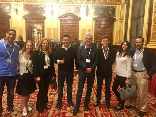 Group photo of eight participants, including Prof. Jürgen Howaldt and Dmitri Domanski, in a ballroom at ISIRC 2019 in Glasgow.